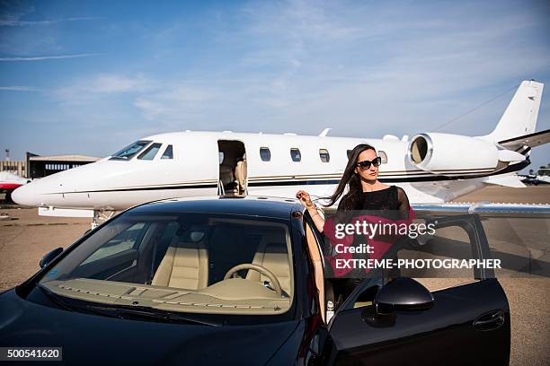 woman arriving by car on airport track - jet black wings stock pictures, royalty-free photos & images