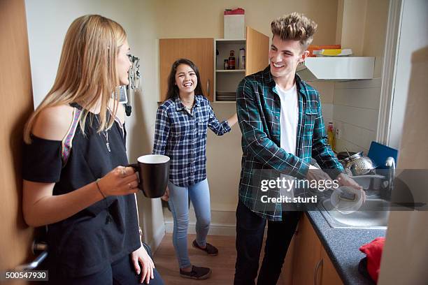 student flatmates in the kitchen - college apartment stock pictures, royalty-free photos & images