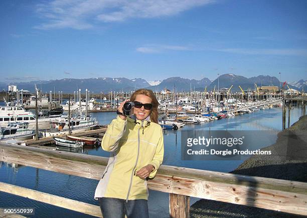 woman filming the beautiful city of homer - homer south central alaska stock pictures, royalty-free photos & images