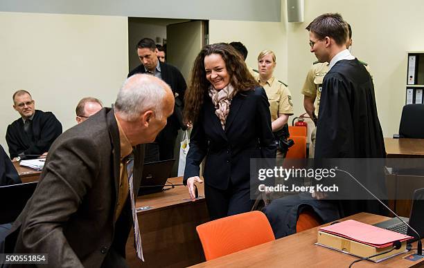 Beate Zschaepe, the main defendant in the NSU neo-Nazi murder trial greets her lawyer Mathias Grasel and Hermann Borchert while co-defandant Ralf...