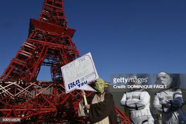 Avaaz activists dressed as Star Wars' Yoda and stormtroopers stand in front of a replica of the Eiffel Tower as they protest during the COP21 United...