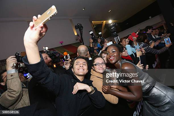 Actress Lupita Nyong'o signs autographs and takes selfies with fans during the "Star Wars: The Force Awakens" Mexico City premiere fan event at...