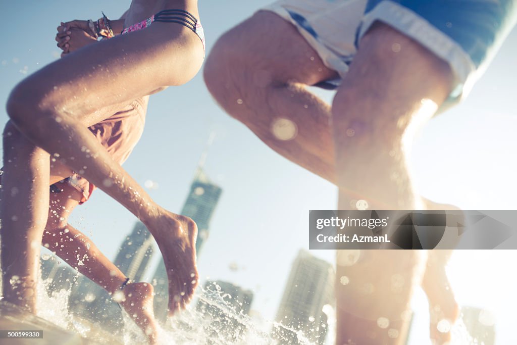 Friends running into sea water