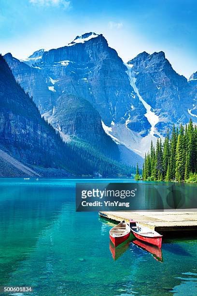 lake moraine and canoe dock in banff national park - canada stock pictures, royalty-free photos & images