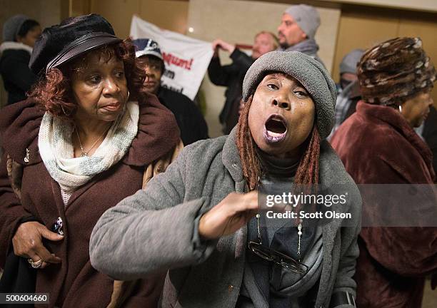 Protestors demonstrate outside the city council chambers y as Chicago Mayor Rahm Emanuel addresses a special session of the City Council as his...