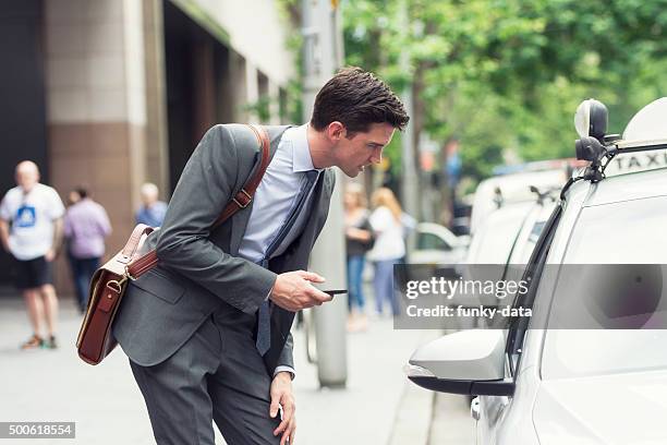 young businessman asking an address to the taxi - australia taxi stock pictures, royalty-free photos & images