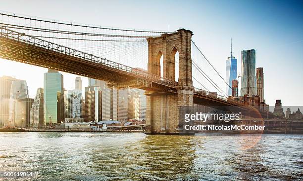 brooklyn bridge from east river sunset with flare - brooklyn new york stockfoto's en -beelden