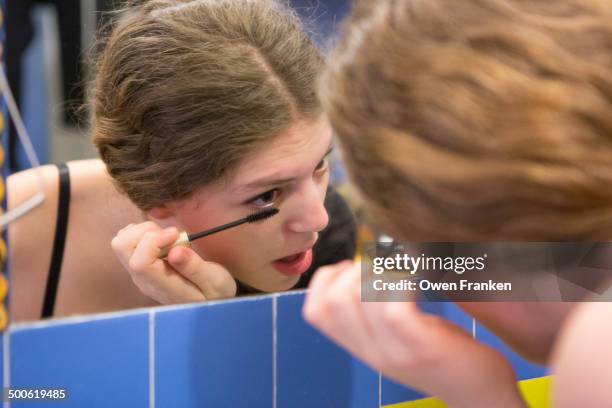 teenage girl putting on makeup - applying mascara stock pictures, royalty-free photos & images