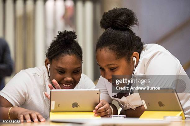 Jiavaennye Green and Taylor Phillips, third grade children from PS 57 James Weldon Johnson Leadership Academy, learn how to code at an Apple Store...