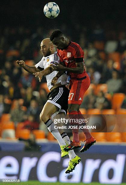 Valencia's Tunisian defender Aymen Abdennour heads a ball with Lyon's forward Maxwell Cornet during the UEFA Champions League football match Valencia...