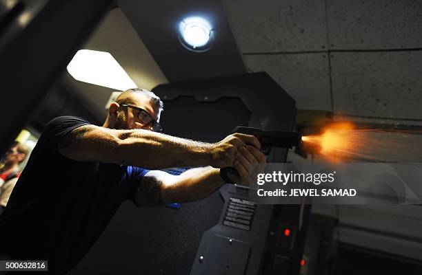 Man fires a handgun as he trains at the RTSP shooting range in Randolph, New Jersey on December 9, 2015. US President Barack Obama called for tougher...