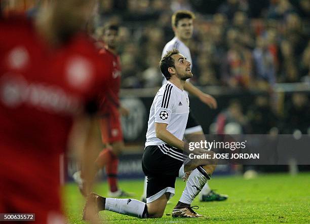 Valencia's forward Paco Alcacer argues with refeere as he kneels on the field during the UEFA Champions League football match Valencia CF vs...