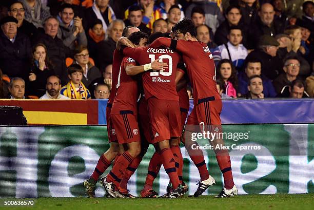 Maxwel Cornet of Lyon celebrates scoring the first Lyon goal with team-mates during the UEFA Champions League Group H match between Valencia CF and...