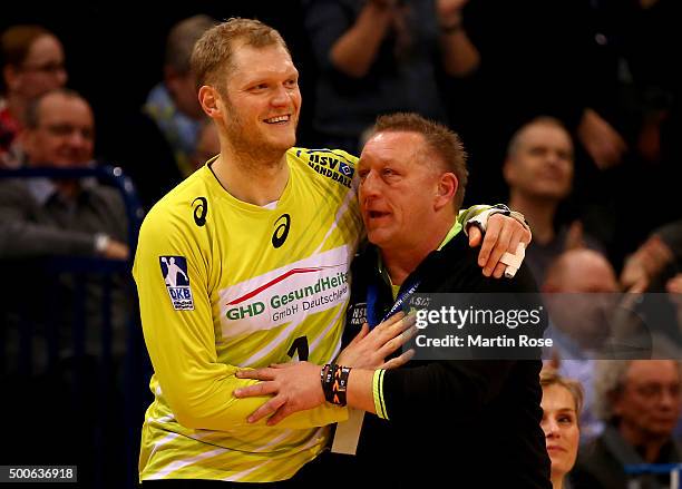 Johannes Bitter, goaltender of Hamburg celebrate with head coach Michael Biegler during the DKB Bundesliga handball match between HSV Handball and...