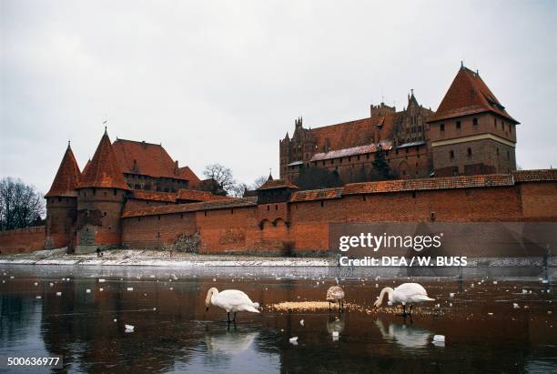 Malbork castle , Castle of the Teutonic Order , on the southeastern bank of the frozen Nogat river, Malbork, Poland, 13th century.