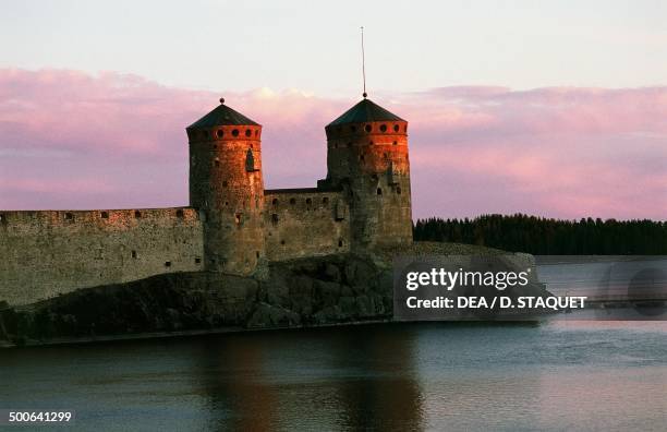 View of Olavinlinna castle at sunset, founded in 1475 by Erik Axelsson Tott, governor of Vyborg and Eastern Provinces, dedicated to Olof, Norwegian...