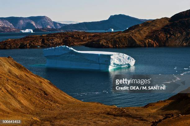 The arctic desert with icebergs in the background, Uummannaq, Qaasuitsup, west Greenland, Denmark.
