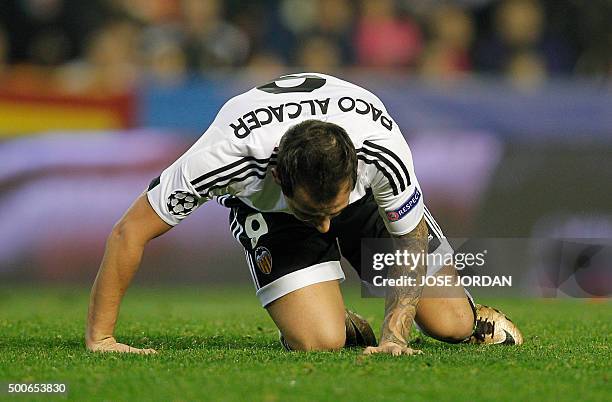 Valencia's forward Paco Alcacer kneels on the ground during the UEFA Champions League football match Valencia CF vs Olympique Lyonnais at the...