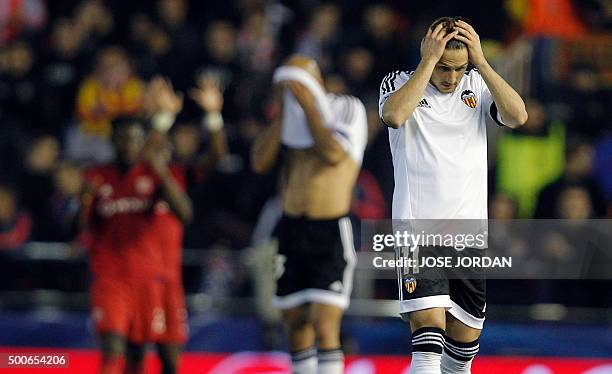 Valencia's Argentinian forward Pablo Piatti gestures after a goal by Lyon during the UEFA Champions League football match Valencia CF vs Olympique...