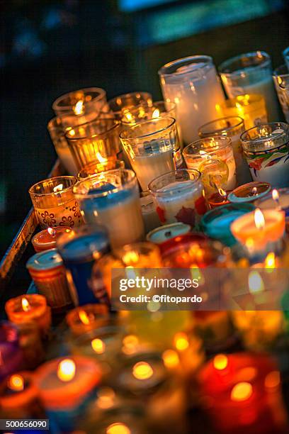 votive candle (lit candle) - religious offering stock pictures, royalty-free photos & images