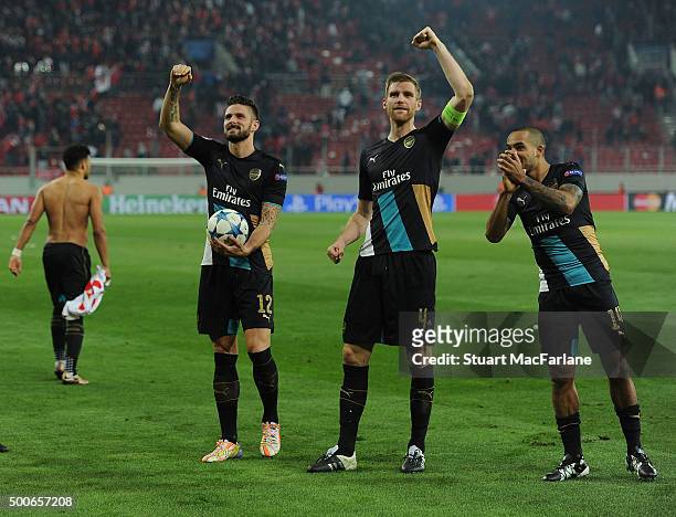Olivier Giroud, Per Mertesacker and Theo Walcott celebrate Arsenal's win after the UEFA Champions League Group F match between Olympiacos and Arsenal...