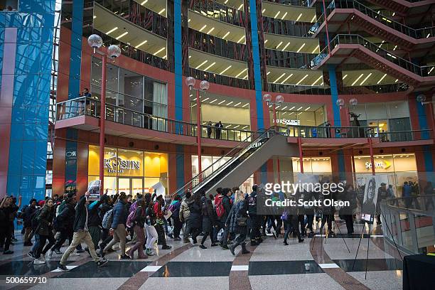 Protestors demonstrate inside the Thompson Center, which houses many state offices, on December 9, 2015 in Chicago, Illinois. About 1,000 protestors...