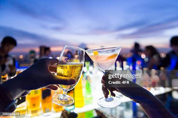 toasting, cheers! - 4 cocktails stock pictures, royalty-free photos & images