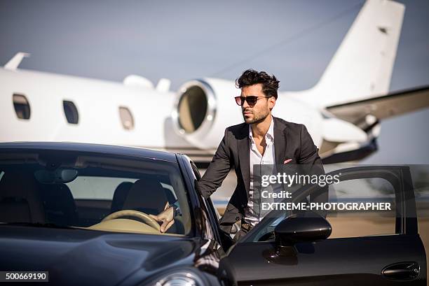 young elegant man arriving at the airport track - extreme wealth stock pictures, royalty-free photos & images