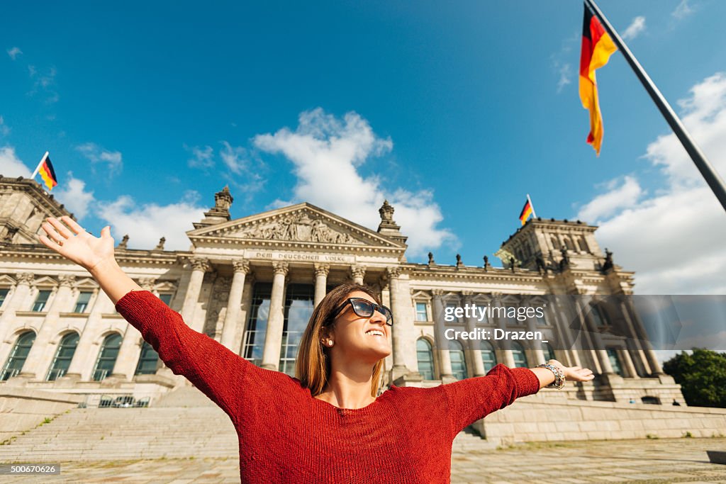 Cheerful woman feels happiness near Bundestag in Berlin, Germany