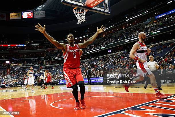 Terrence Jones of the Houston Rockets celebrates after dunking the ball in front of Marcin Gortat of the Washington Wizards in the first half at...