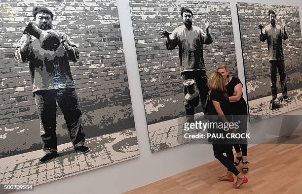Patrons view 'Dropping a Han Dynasty Urn' , a piece made of Lego blocks by Chinese dissident artist Ai Weiwei, following the launch of the joint...