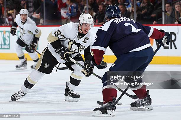 Sidney Crosby of the Pittsburgh Penguins controls the puck against Nick Holden of the Colorado Avalanche at Pepsi Center on December 9, 2015 in...