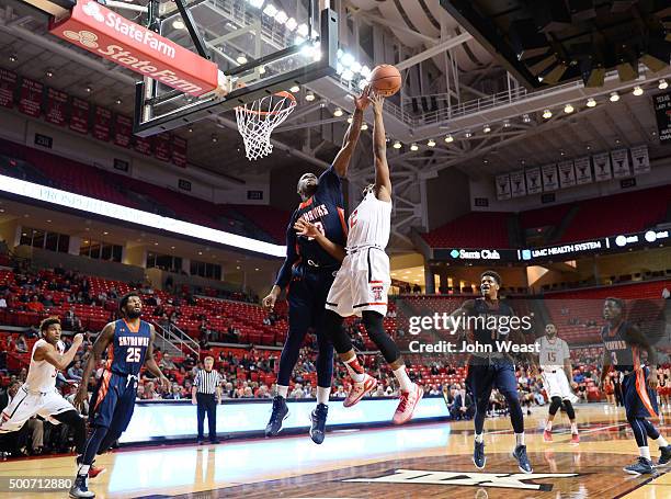 Myles Taylor of the Tennessee-Martin Skyhawks blocks the shot of Devon Thomas of the Texas Tech Red Raiders during the game on December 09, 2015 at...