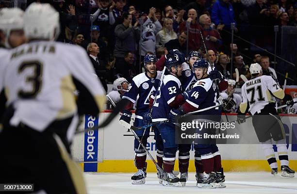 Colorado Avalanche players celebrate after Erik Johnson of the Colorado Avalanche during the first period at the Pepsi Center on December 9, 2015 in...