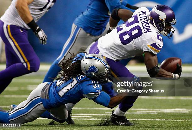 Adrian Peterson of the Minnesota Vikings is tackled by Rashean Mathis of the Detroit Lions at Ford Field on October 25, 2015 in Detroit, Michigan....