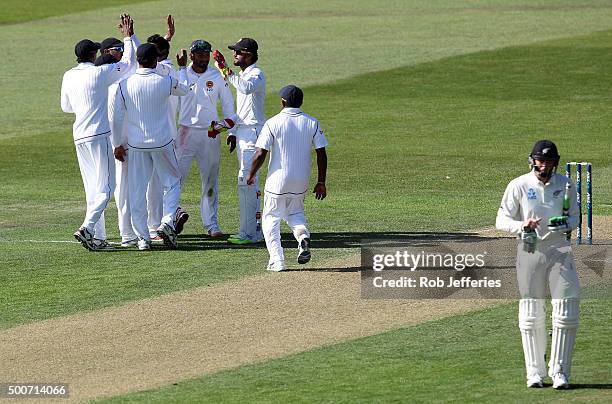 Martin Guptill of New Zealand departs after being dismissed caught by Dinesh Chandimal of Sri Lanka off the bowling of Angelo Mathews during day one...