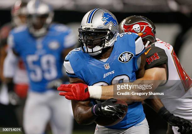 James Ihedigbo of the Detroit Lions tries to escape the tackle by Luke Stocker of the Tampa Bay Buccaneers at Ford Field on December 07, 2014 in...