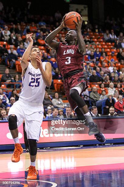 Guard Munis Tutu of the Loyola Marymount Lions drives to the hoop against the defense of guard Lonnie Jackson of the Boise State Broncos during...