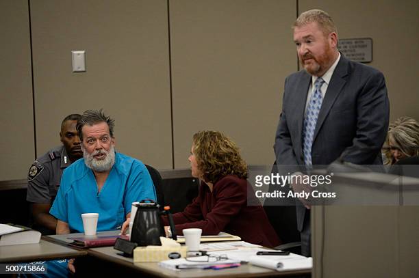 December 09: Attorney Rose Roy, center, tries to quite client Robert Dear Jr. During an outburst while attorney Daniel King argues on Dear's behalf...