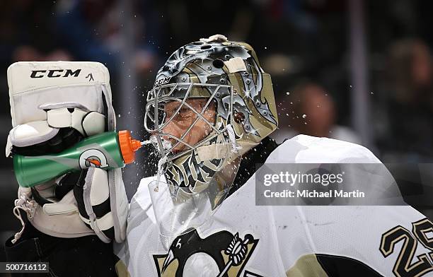 Goaltender Marc-Andre Fleury of the Pittsburgh Penguins sprays himself with water through his mask during a break in the action against the Colorado...