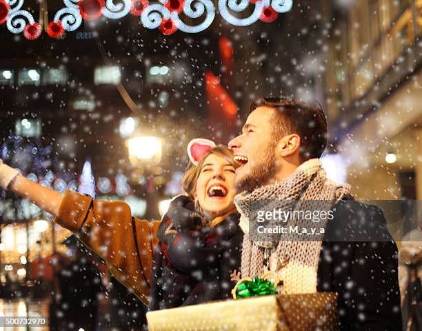 having fun outdoors on christmas - woman snow outside night stockfoto's en -beelden