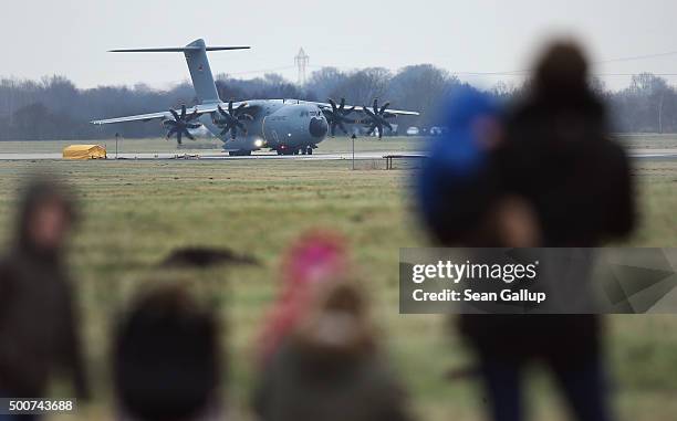 Family members of departing soldiers watch as a Luftwaffe A-400M plane transporting 40 Bundeswehr members and their equipment prepares to depart for...