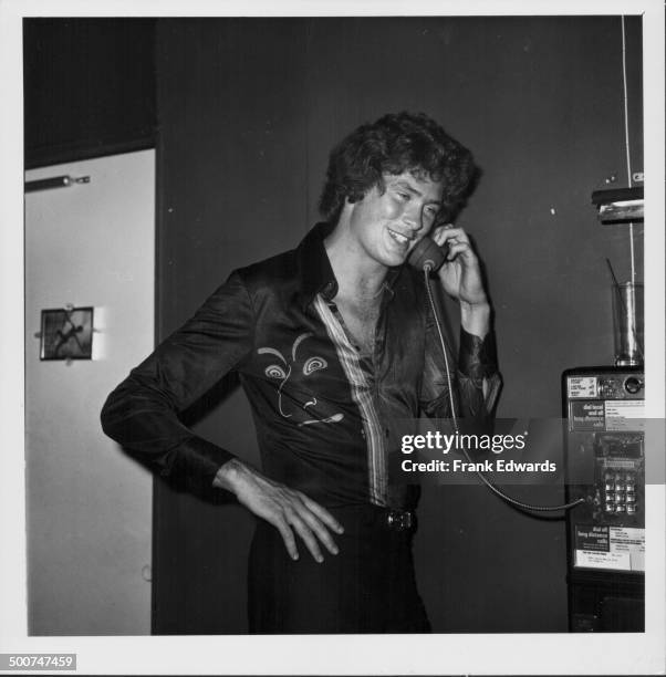 Actor David Hasselhoff using a public telephone, at the opening of the new restaurant 'Flick', West Hollywood, California, May 1976.