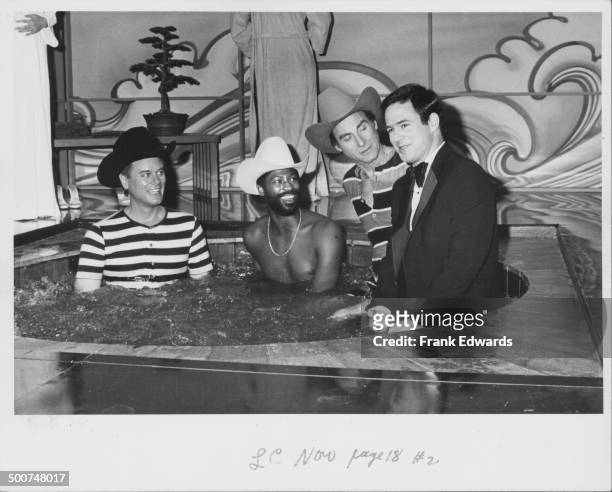 Actor Larry Hagman, singer Teddy Pendergrass, and comedians Sid Caesar and Jeff Altman, sitting together in a hot tub, in a skit from the show 'Pink...