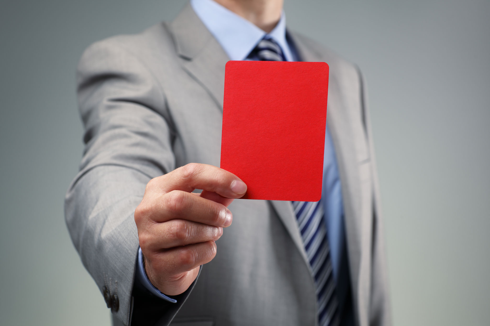 Businessman showing the red card Businessman showing the red card