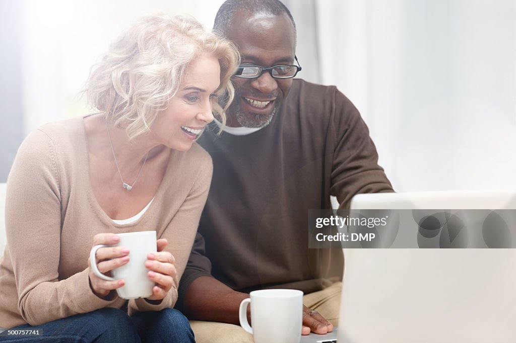 Interracial couple using laptop at home