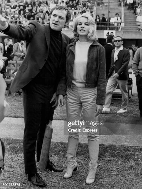 Actor Richard Harris explaining the rules of cricket to actress Carroll Baker, at a Celebrity Cricket Match for Charity, Santa Monica, California,...