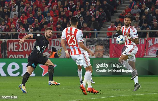 Olivier Giroud of Arsenal scores the first goal for Arsenal during the UEFA Champions League Group F match between Olympiacos FC and Arsenal FC at...