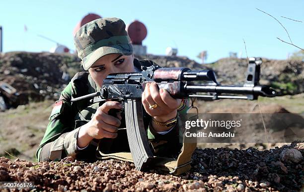 Female fighters aims her rifle as the Syrian Peshmerga fighters are being trained to fight against Daesh and Assad forces at a camp located in Old...