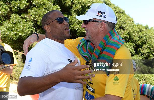 In this handout image provided by Philip Brown, Sir Ian Botham is pictured with former footballer John Barnes during his latest fundraising walk the...